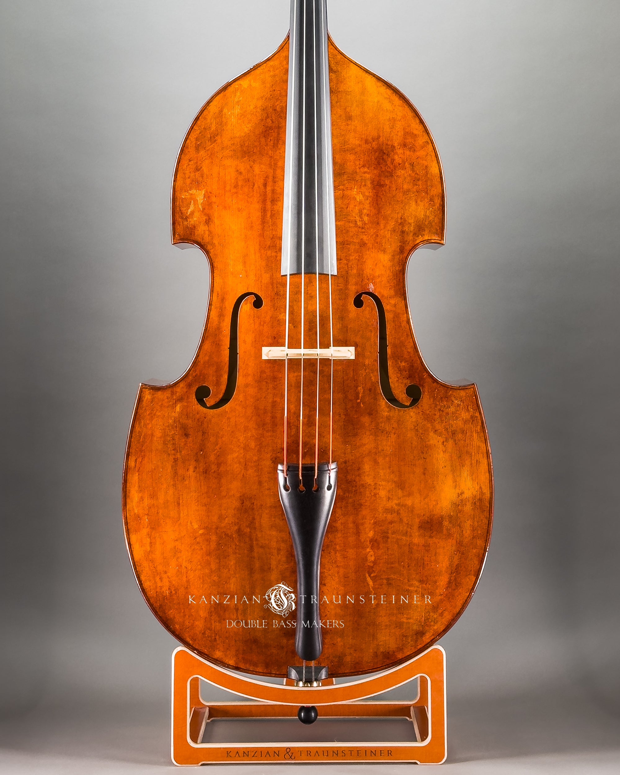 Frontal close up view of Kanzian & Traunsteiner double bass with antique finish made in 2026