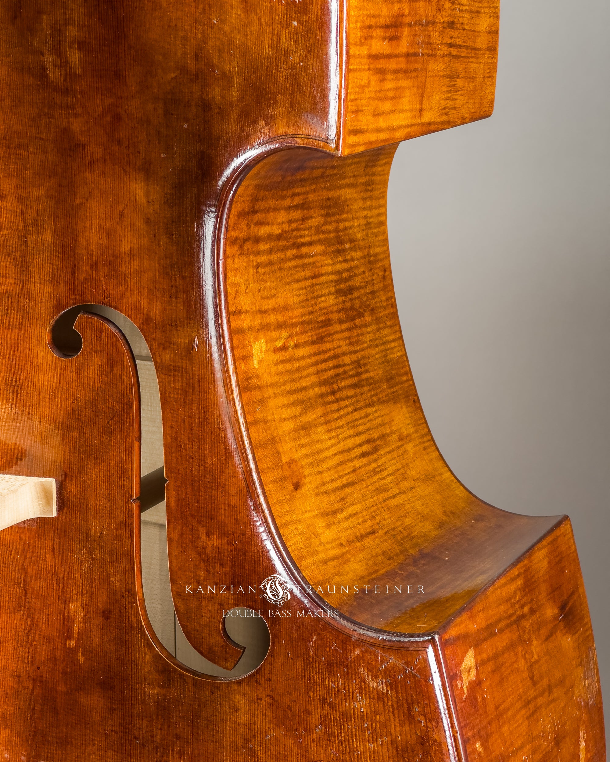 C bout and soundhole detail of Kanzian & Traunsteiner double bass with antique finish made in 2026