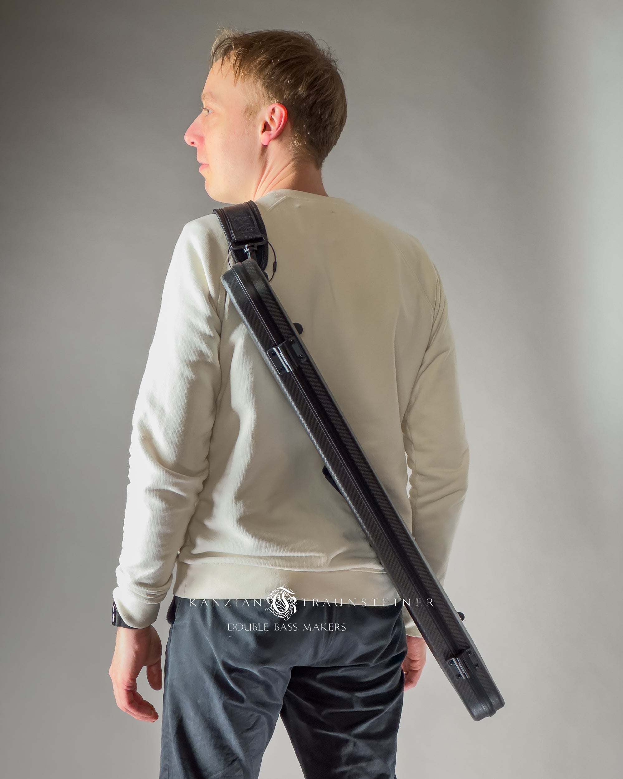 Model carries Bogaro e Clemente carbon fibre double bass bow case